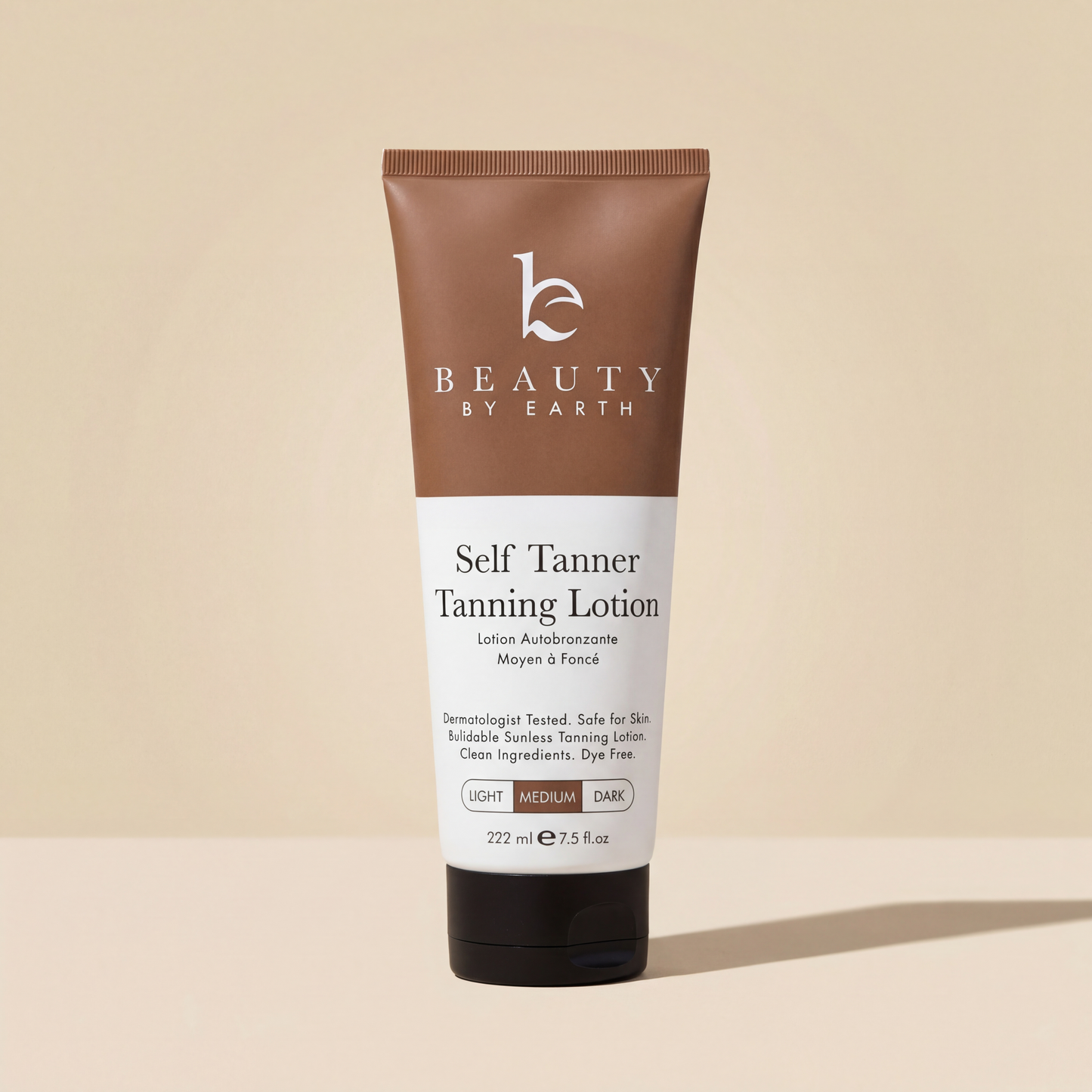 Beauty by Earth Self Tanner Body Lotion in Medium, 7.5 fl oz tube on a beige background