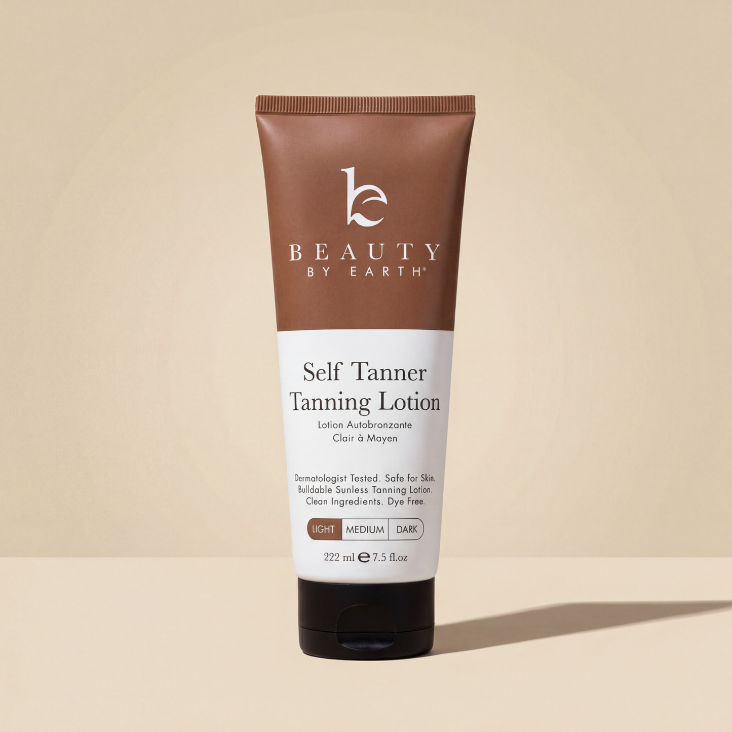 Beauty by Earth Self Tanner Body Lotion in Light, 7.5 fl oz tube on a beige background